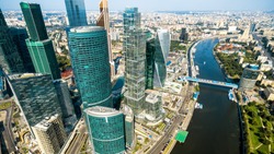 Aerial panoramic view of Moscow with Moskva River, Russia. Cityscape of Moscow with business skyscrapers of Moscow-City. The look of the city from above. Panorama of the modern buildings of Moscow.