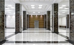Marble interior of luxury lobby of commercial building or hotel. Clean corporate hall with real floor tile. Shiny floor with reflections in modern office after professional cleaning service.