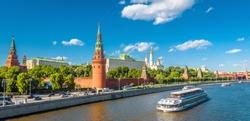 Moscow Kremlin in summer, Russia. Famous Moscow Kremlin is a top tourist attraction of city. Panoramic view of the beautiful Moscow landmark. Cityscape of the Moscow center and ship on Moskva River.