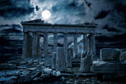 Ancient Greek temple at night, Athens, Greece, Europe. View of mystery Parthenon on Acropolis, Ancient ruins on dramatic sky background. Theme of historic Greece, past civilization, time and history.