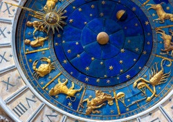 Astrological signs on ancient clock Torre dell'Orologio, Venice, Italy. Medieval Zodiac wheel and constellations. Golden symbols on star circle. Concept of astrology, horoscope and time.