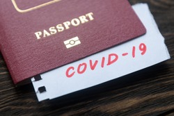 Coronavirus, travel and health concept, COVID-19 note in tourist passport. Medical test at border control due to pandemic restrictions. Business, immigration and tourism hit by corona virus.