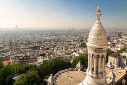 Paris view from Sacre Coeur on Montmartre hill, France. Basilica of Sacre Coeur (Sacred Heart) is famous landmark of city. Nice panorama, skyline of Paris in summer. Sightseeing of Montmartre.