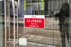 Business center closed due to COVID-19, sign with sorry in door. Stores, offices, other commercial buildings temporarily closed during coronavirus pandemic. Economy crisis and lockdown concept.
