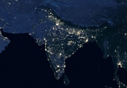 Earth at night, view of city lights showing human activity in India from space. Part of South Asia on world dark map on global satellite photo. Elements of this image furnished by NASA.