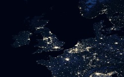 Earth at night, view of city lights showing human activity in UK, Netherlands and Belgium from space. Part of Europe on world dark map on global satellite photo. Elements of image furnished by NASA.