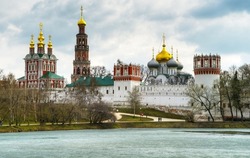 Novodevichy convent in Moscow, Russia. Novodevichy monastery is historical landmark of Moscow. Scenic view of Russian Orthodox cloister in spring. Old architecture of Moscow at ice pond.
