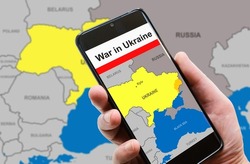 War in Ukraine on smartphone screen. Media news, military conflict in mobile phone. Ukraine and Russia borders with Donbass on Europe map. Concept of social network, internet, fake, online and crisis