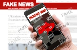 War in Ukraine and Fake News theme, Russia and Ukraine conflict on mobile phone screen. Russia vs Ukraine in media. Concept of politics, communication technology, false, information warfare and wrong.