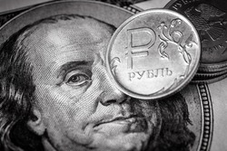 Ruble coin vs US dollar bill, money of Russia and USA. Concept of Russian economy crisis, sanction tension, ruble gas payment, finance, currency exchange rate and inflation. Black and white photo.
