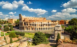 Colosseum (Coliseum) in Rome, Italy, Europe. It is main travel attraction of Rome. Skyline of Rome, panoramic scenic view of Colosseum in summer. Panorama of ancient Roman architecture in Rome city.