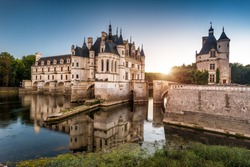 Castle chateau de Chenonceau in Loire Valley, France. It is French landmark located near small village of Chenonceaux. Scenic view of old castle on River Cher at sunset. Sightseeing and travel theme.
