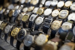 Close up shot of some vintage watches on display in a shop.