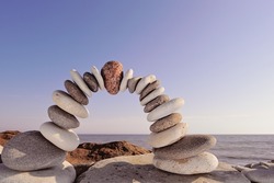 Red stone in the center arch of pebbles