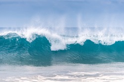 Powerful wave breaks along the shore
