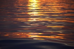 Mediterranean sea at sunrise. Golden sunlight reflecting in the water. Abstract natural pattern, texture, background, seascape, concept image, graphic resources