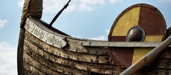 Old wooden viking snekkja longship type, close-up. Nautical vessel, tall ship, traditional craft, vintage, landmark, history, past, historical reenactment, nordic culture