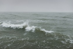 Baltic sea in a fog. Waves, splashing water, storm. Natural textures. Picturesque panoramic monochrome scenery, seascape. Nature, environment, rough weather, danger