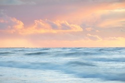 Sea waves and splashes texture. Colorful sky reflecting in the water. Idyllic seascape. Concept image, long exposure. Picturesque scenery. Background, wallpaper, natural pattern, graphic resources