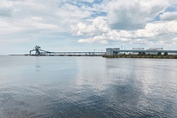 Cargo port terminal. Cranes, grain elevator. Ventspils, Latvia, Baltic sea. Freight transportation, logistics, global communications, supply, economy, industry, ecology, pollution