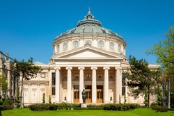 Historical landmark and vintage music hall concept with a daytime view of the Romanian Athenaeum (or Ateneul Roman), opened in 1888 to be the main concert hall in the city of Bucharest, Romania