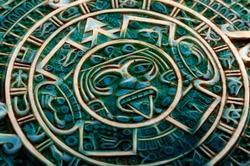 Pre Columbian culture and indigenous civilizations concept them with close up on a aztec sun calendar made of semi precious jade stone