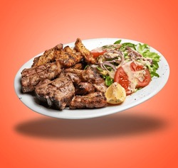 Floating White plate with Mixed meat grilled and salad  on orange gradient background