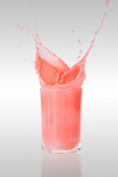 strawberry milk shake splashing put of a glass on isolated back ground