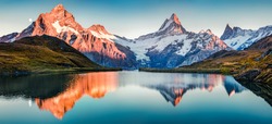 Fantastic evening panorama of Bachalp lake / Bachalpsee, Switzerland. Picturesque autumn sunset in Swiss alps, Grindelwald, Bernese Oberland, Europe. Beauty of nature concept background.