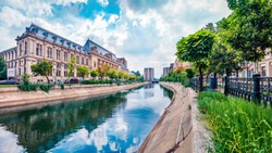 Amazing morning cityscape of Bucharest city - capital of Romania, Europe. Colorful summer view of Court of Appeal Building on tne Dambovita river. Traveling concept background.