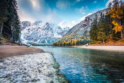 First snow in the mountains. Picturesque autumn view of Braies Lake. Stunnig morning scene of Dolomiti Alps, Naturpark Fanes-Sennes-Prags, Italy, Europe. Beauty of nature concept background.