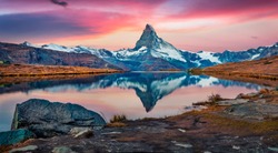 Majestic morning view of Stellisee lake with Matterhorn peak on background. Captivating autumn scene of Swiss Alps, Switzerland, Europe. Beauty of nature concept background.