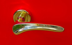 golden door handle on a red background