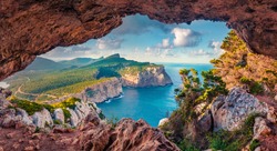 Astonishing summer view of Caccia cape from the small cave in the cliff. Fabulous morning scene of Sardinia island, Italy, Europe. Aerial Mediterranean seascape. Beauty of nature concept background.