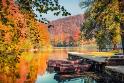 Beautiful autumn scenery. Stunning morning view of pure water lake with boats in Plitvice National Park. Colorful autumn scene of Croatia, Europe. Beauty of nature concept background.