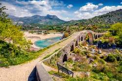 Amazing spring view of Old Mes Bridge. Stunning morning landscape of Shkoder. Picturesque outdoor scene of Albania, Europe. Traveling concept background.