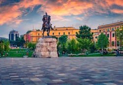 Splendid spring view of monument of Skanderbeg in Scanderbeg Square. Picturesque sunset in capital of Albania - Tirana. Traveling concept background.