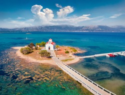 View from flying drone of Saint Spiridon church in Elafonisos port. Colorful morning seascape of Mediterranean Sea. Spectacular outdoor scene of Elafonisos island, Greece. Traveling concept background