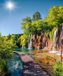 Picturesque summer view of green forest with pure water waterfall in Plitvice National Park. Sunny morning landscape of Croatia, Europe. Beauty of nature concept background.