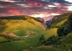 Dramatic sunset on Cheile Turzii (Turzii's Gorge) canyon, large natural preserve with marked trails for scenic gorge hikes crossing streams and bridges. Beauty of nature concept background.