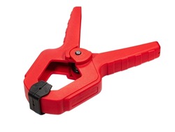 Red plastic clamp with black tip isolated on white background. Clamping equipment for handicraft, joinery and photography. 