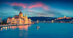 Evening view of Parliament, Chain Bridge and Buda Castle. Colorful sanset in Budapest, Hungary, Europe. Artistic style post processed photo.