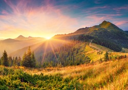 Amazing summer sunrise in Carpathian mountains. Colorful morning scene with first sunlight glowing hills and valleys. Beauty of nature concept background. Artistic style post processed photo.