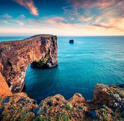 Incredible evening view of Dyrholaey arch. Dramatic summer sunset in Dyrholaey Nature Reserv, south coast of Iceland, Europe. Beauty of nature concept background.
