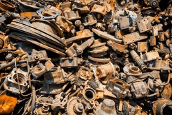 Pile of old rusty metal scrap, used machine spares and car parts can be used as mechanic industrial background