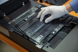 Digitization scanning of photographic film negatives on the scanner. Converting an image to digital form.