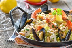 Tasty Spanish paella with seafood and chicken breast
