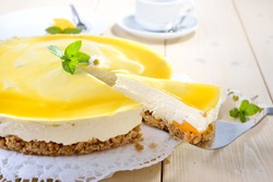 Fresh cheesecake with mango fruit and glaze, the flan case made of cookie crumbs