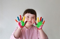 Cute little girl with painted hands. 