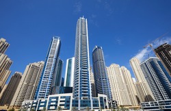 Dubai Marina new and under construction skyscrapers in a sunny day, clear blue sky in Dubai